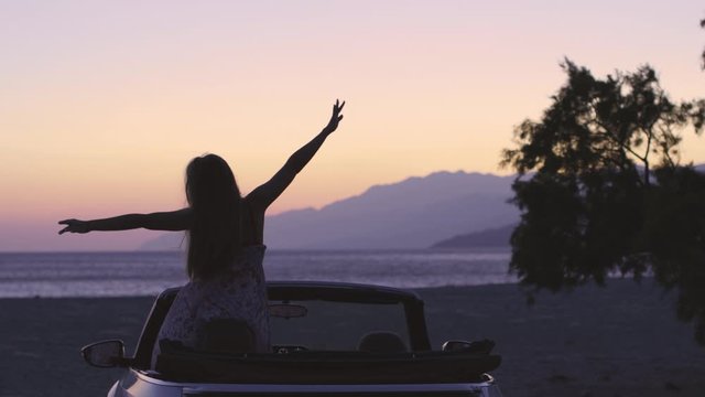 Young Woman in Cabriolet at Sunset