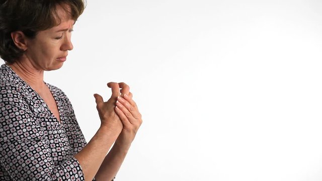 A woman who is experiencing arthritic pain in her fingers.
