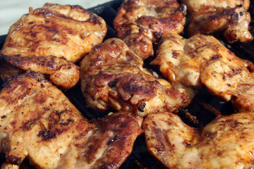 Chicken wings getting grilled on open fire