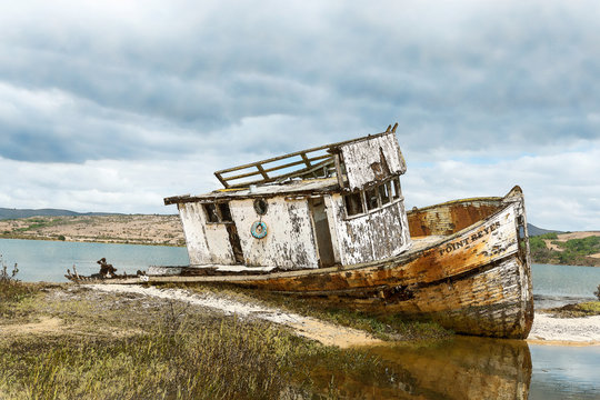 abandoned fishing boat on beach with watercolor effect - Powered by Adobe