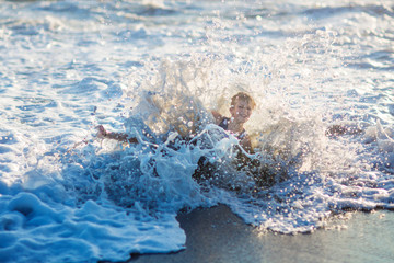 boy playing on the waves