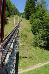Fototapeta na wymiar Switzerland: The world strongest rise cog railway with up to 48% grade driving up mount Pilatus at Lake Lucerne