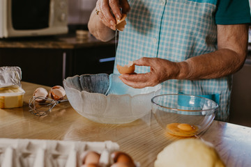 senior woman making egg white for christmas cakes and candy, pastry
