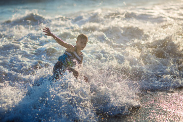 boy playing on the waves