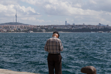 the old man walking by the sea alone.