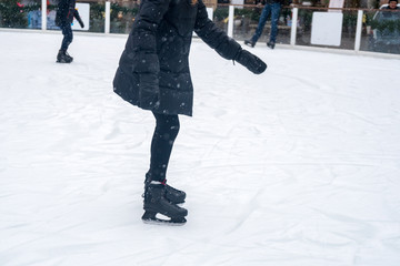 Fototapeta na wymiar Closeup view of ice skates on outdoor ice rink for habitants. Ice skating in winter.