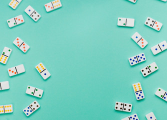 Frame of dominoes on mint green background