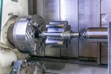 A machining center in the industry, manufacturing a gear shaft on a cnc machine.