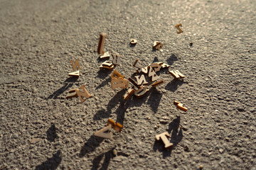 Letters fall on the asphalt, tinted photo of the English alphabet, learning and science.