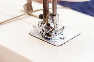 Sewing machine, closeup needle and presser foot with holder.