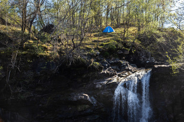 tent piched at the top of the falls of falloch