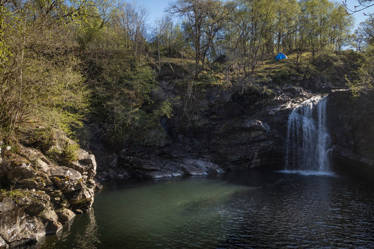 tent piched at the top of the falls of falloch