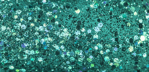 Mint colored holiday glitter background. Blurred festive green backdrop for your design. Holiday concept