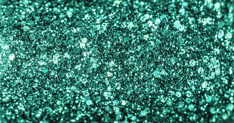 Mint colored holiday glitter background. Blurred festive green backdrop for your design. Holiday concept