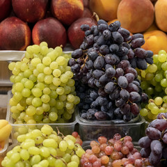 Different types of grapes on the shelves of the farmer's market, open shelves, showcases. Healthy organic food. Autumn harvest