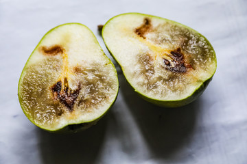 Sectional rotten worm pear, two halves
