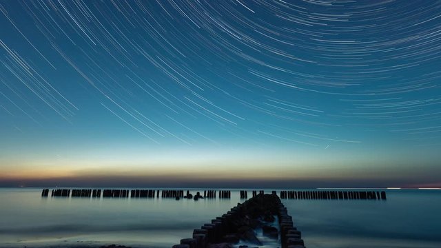 Night sky with stars and startrail. Baltic Sea location in a famous polish tourist city Miedzyzdroje