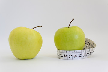 two green apple and measuring tape slim body weight control