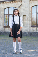 School fashion. Girl wear fashionable outfit. White shirt and black dress. Classic style. Formal clothes for visiting school. Daily outfit. Adorable schoolgirl. Perfect matching clothes. Kids clothes