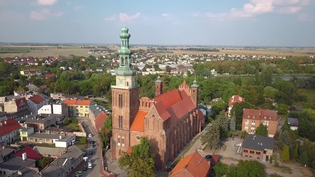 Aerial: Flight around the old medieval church in Chelmza, old city in Poland.