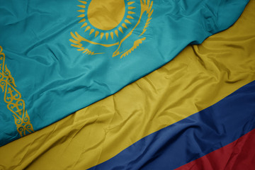 waving colorful flag of colombia and national flag of kazakhstan.