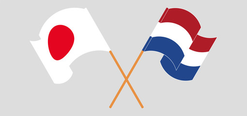 Crossed and waving flags of Netherlands and Japan