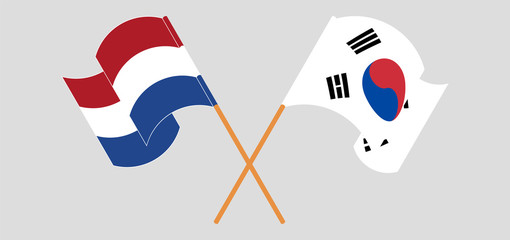 Crossed and waving flags of Netherlands and South Korea