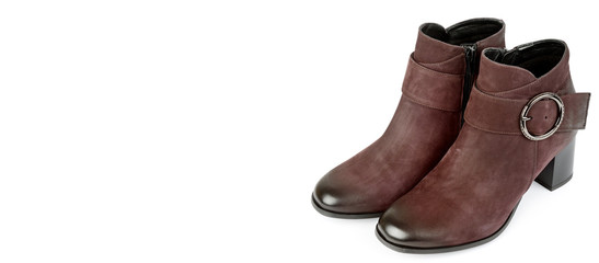 Stylish suede ankle boots isolated on white background. Free space for text. Wide photo.