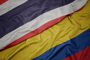waving colorful flag of colombia and national flag of thailand.