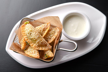 Azerbaijani cuisine. Sambusiki with spinach on a white plate