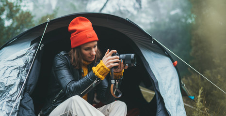 photographer girl hold in hands mobile phone taking photo on smartphone autumn foggy mountain, tourist shooting on photo camera on background landscape, internet online concept