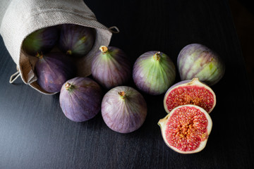 Top view of bunch of purple figs on a bag