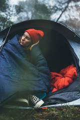 tourist traveler ralaxing in camp tent in foggy rain forest, lonely hiker woman enjoy mist nature trip, green trekking tourism, rest vacation concept camping holiday