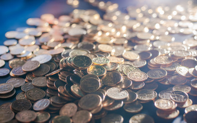 Banking and money trading. Metal coins stacked in different combinations on dark blue blurred background and lens flare. Serbian metal coins, copy space. Close up of metal money. Business concept