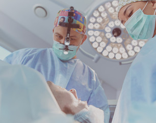 Man surgeon at work in operating room