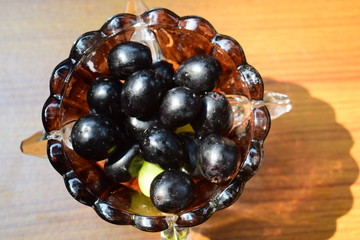grapes in a vase on black background