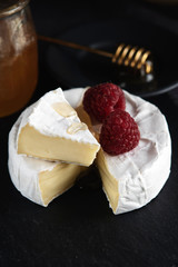 coffe, camembert, raspberries, honey on a dark backgraund minimalistic, breakfast
