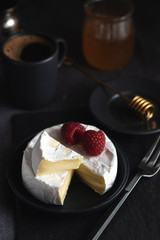 coffe, camembert, raspberries, honey on a dark backgraund minimalistic, breakfast
