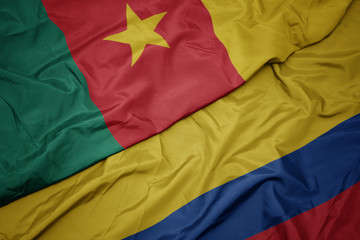 waving colorful flag of colombia and national flag of cameroon.