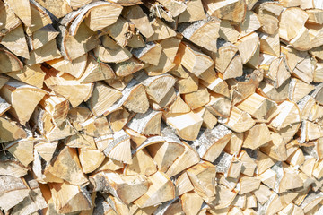 Dry chopped firewood lay in a pile on the street