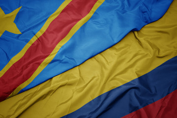 waving colorful flag of colombia and national flag of democratic republic of the congo.