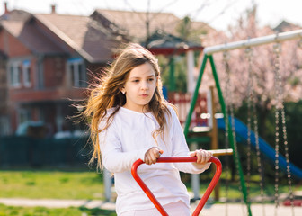 young girl on teeter at playground