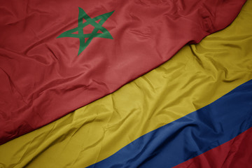 waving colorful flag of colombia and national flag of morocco.