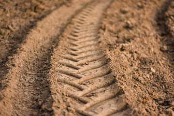 Traces of car tires on the road , car footprints in the sand.