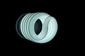Coiled light bulb on a dark bakground