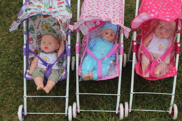 baby dolls in colorful strollers