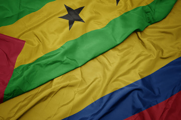 waving colorful flag of colombia and national flag of sao tome and principe .