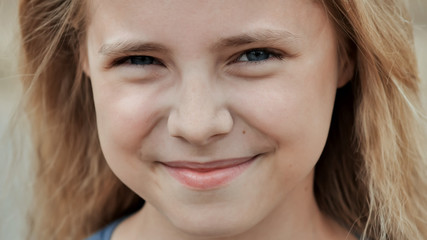 Portrait of a young smiling 11 year old girl. Face close up.