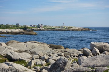 Fototapeta na wymiar Landscape view of the picturesque Peggy’s Cove fishing village on the ocean shore outside of Halifax, capital of the Canadian province of Nova Scotia, in St Margaret’s Bay
