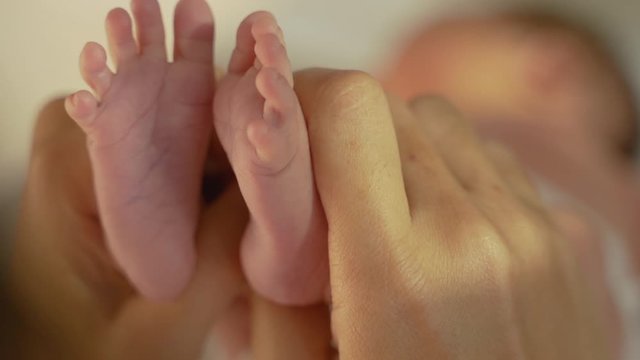 close up of Mother hands holding small baby feet